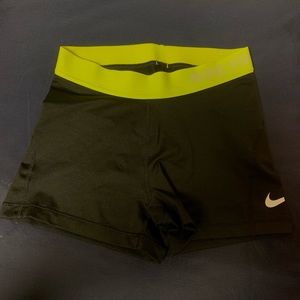 Black Nike Pros with yellow waistband